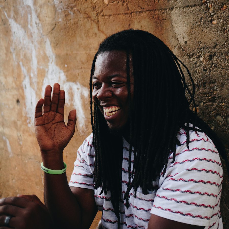 A smiling man waving