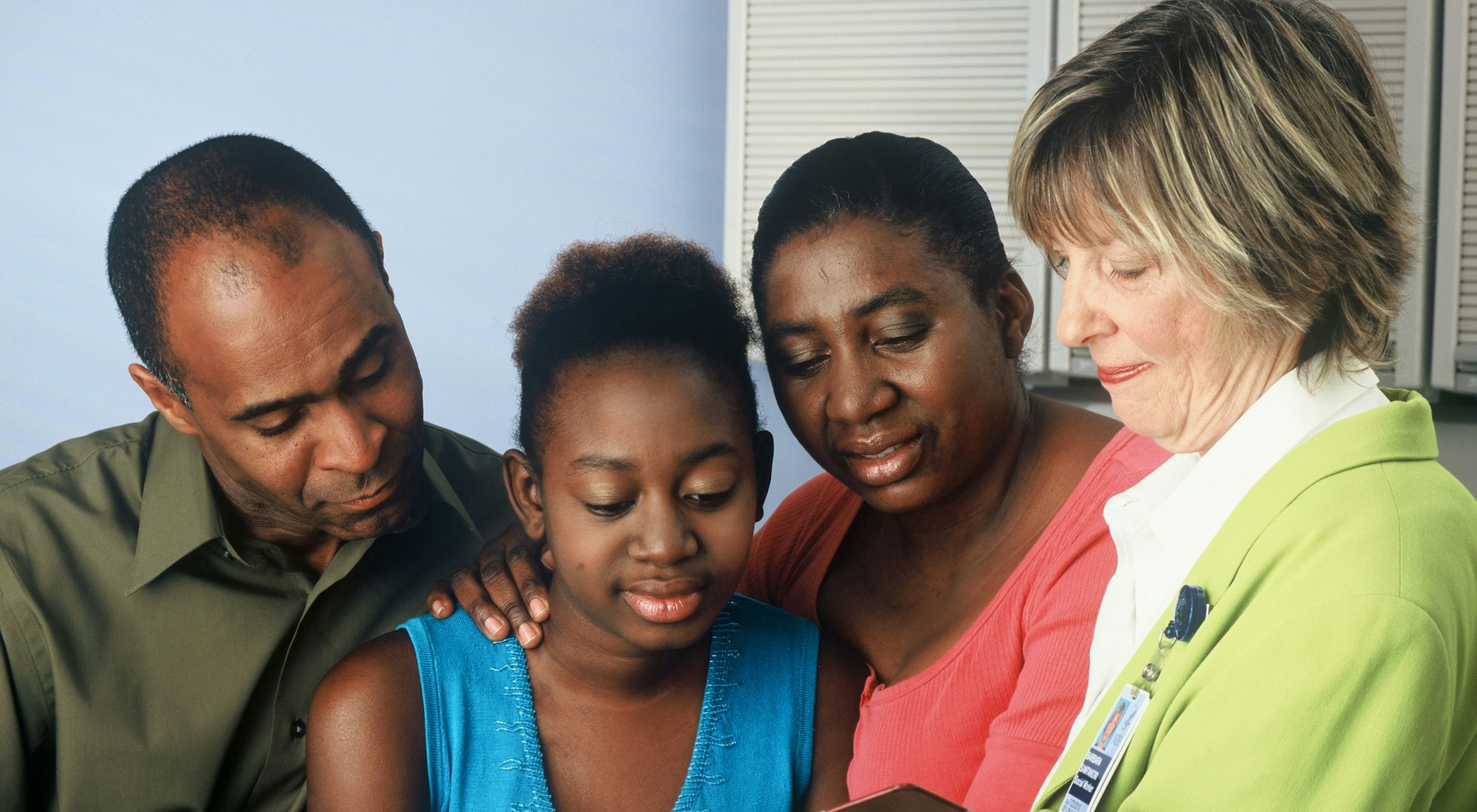 A family reading together with a mentor