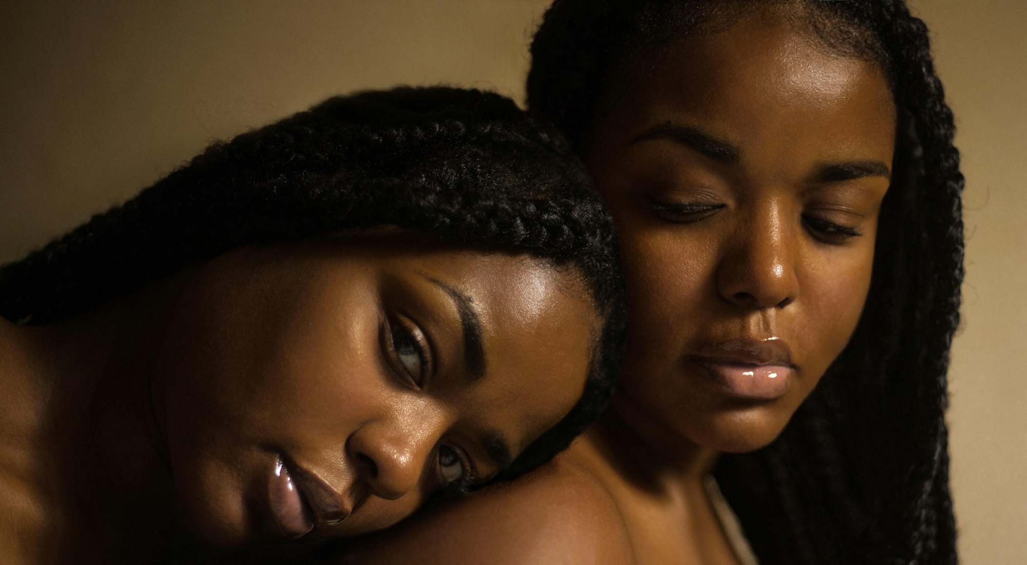 Two women resting their heads together