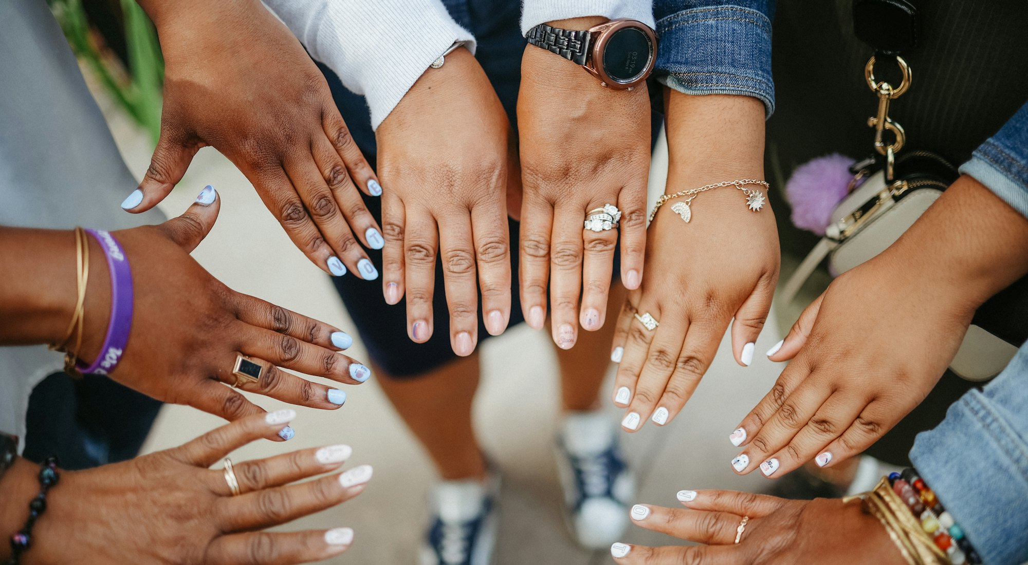 Many hands gathered in a circle